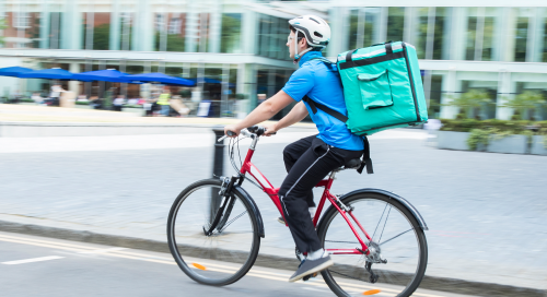 Man with a delivery bag on his bike