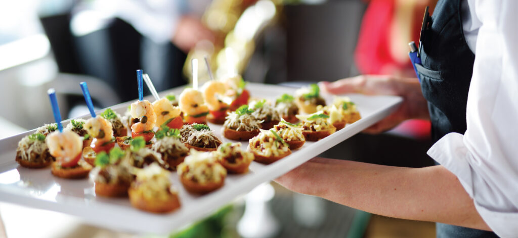 hospitality worker carrying a catering tray